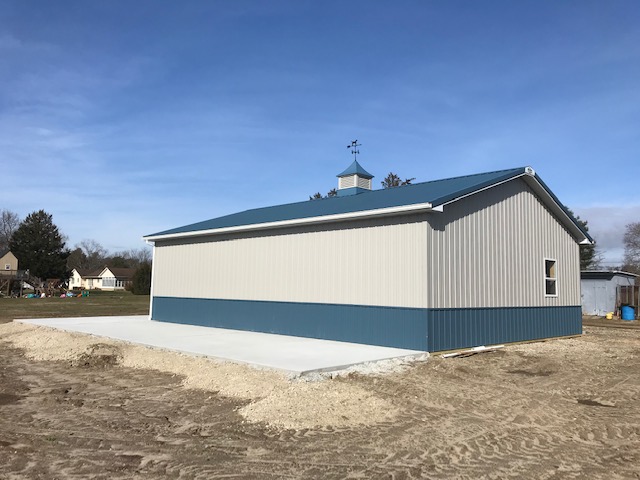 teal and tan metal barn