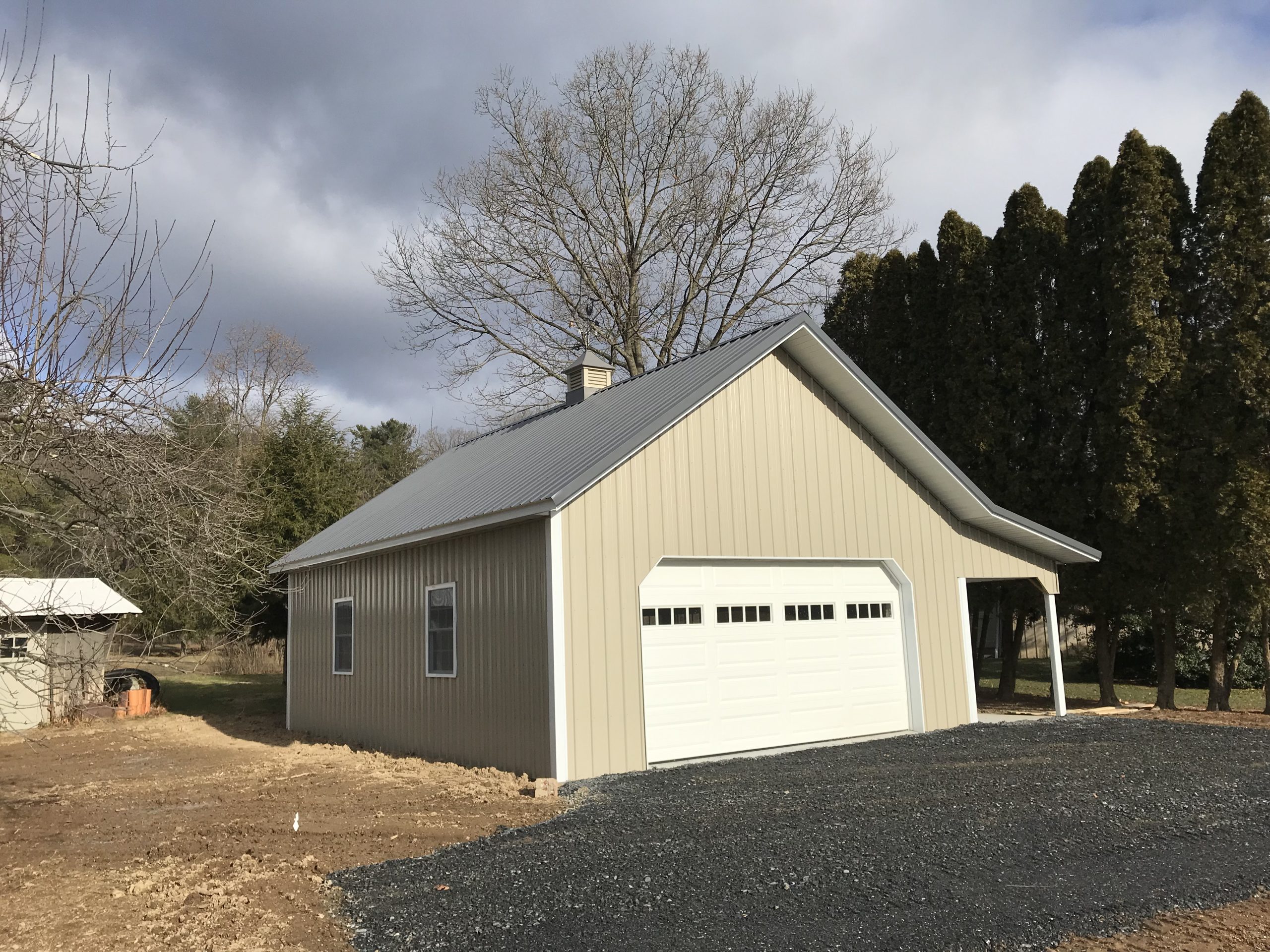 tan metal agricultural post frame garage